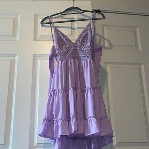 Lilac Mini dress w/ Ruffled bottom and detailed lace bodice, open back and tie.